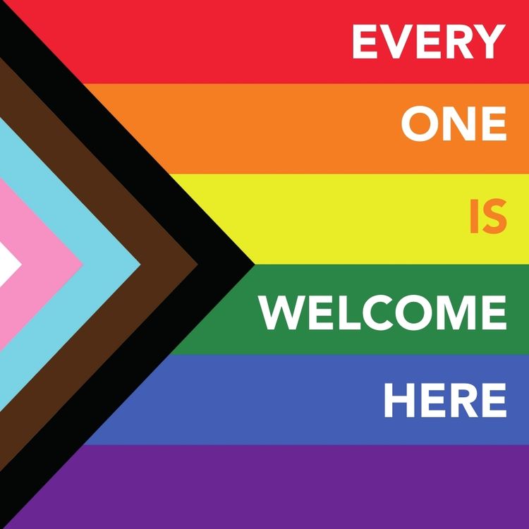Progressive rainbow flag with the text saying "everyone is welcome here".